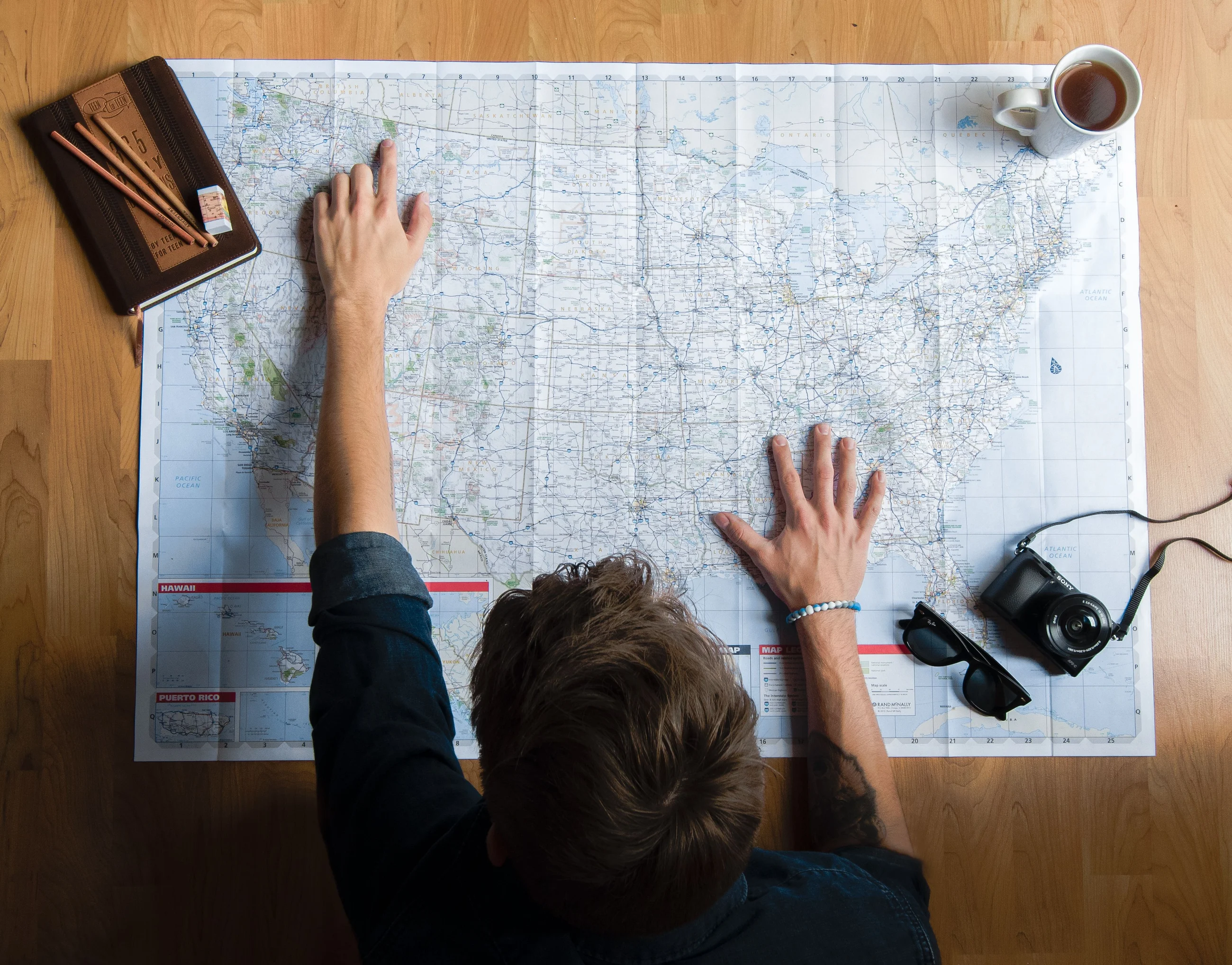 A traveller planning a route on a printed road map