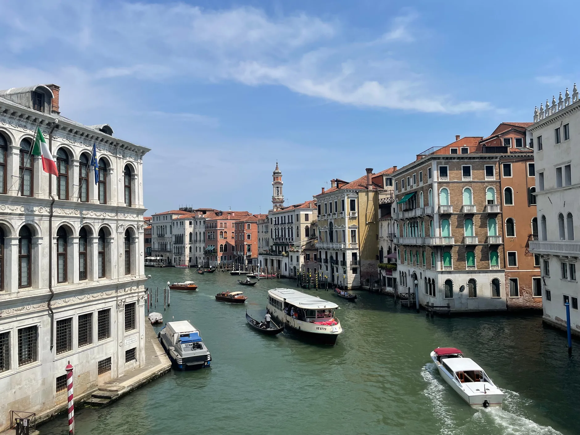 A water bus, a gondola and motorboats on the Grand Canal in Venice
